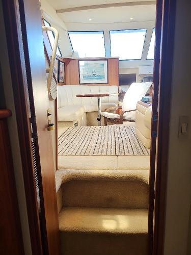 Slide: The Image of Interior of a 2000 Silverton 392 Motor Yacht with cozy seating and natural light. - 43