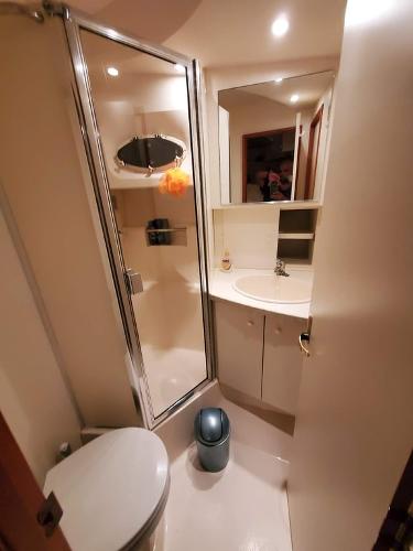 Slide: The Image of Bathroom interior of a 2000 Silverton 392 Motor Yacht with shower, sink, and toilet. - 45