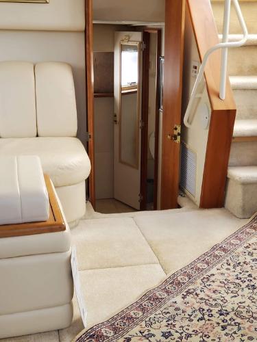 Slide: The Image of Interior of 2000 Silverton 392 Motor Yacht with beige seating and carpeted stairs. - 46