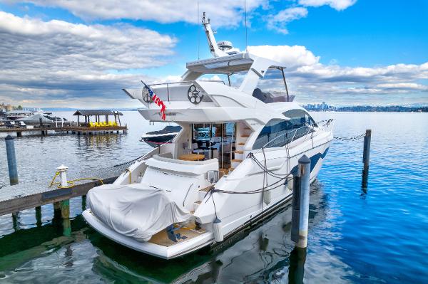 Slide: The Image of 2017 Sunseeker Manhattan 52 yacht docked at a marina on a sunny day. - 1