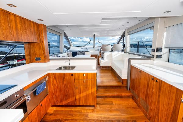 Slide: The Image of Luxurious interior of 2017 Sunseeker Manhattan 52 yacht with modern kitchen and panoramic windows. - 11