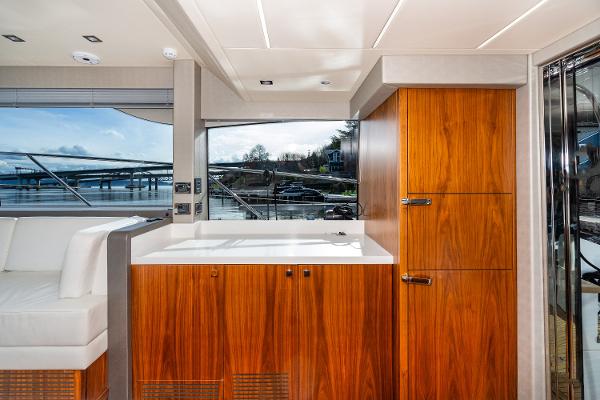 Slide: The Image of Interior of 2017 Sunseeker Manhattan 52 yacht with wooden cabinetry and waterfront view. - 15