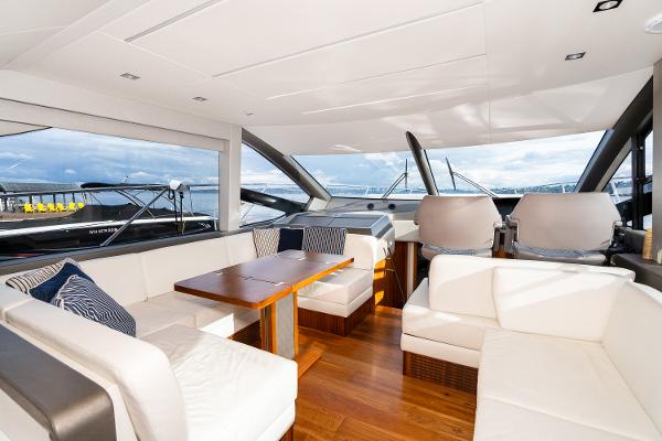 Slide: The Image of Luxurious interior of 2017 Sunseeker Manhattan 52 yacht with white seating and wooden table. - 17