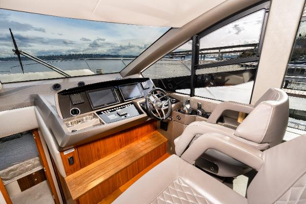 Slide: The Image of 2017 Sunseeker Manhattan 52 yacht helm station with modern controls and panoramic view. - 20