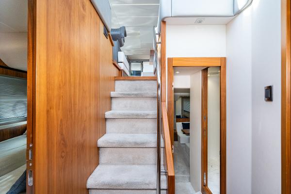 Slide: The Image of Interior staircase of 2017 Sunseeker Manhattan 52 yacht with wooden accents and carpeted steps. - 25