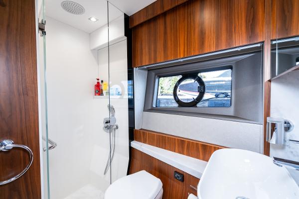 Slide: The Image of Luxurious bathroom in 2017 Sunseeker Manhattan 52 yacht with modern fixtures and wood accents. - 41