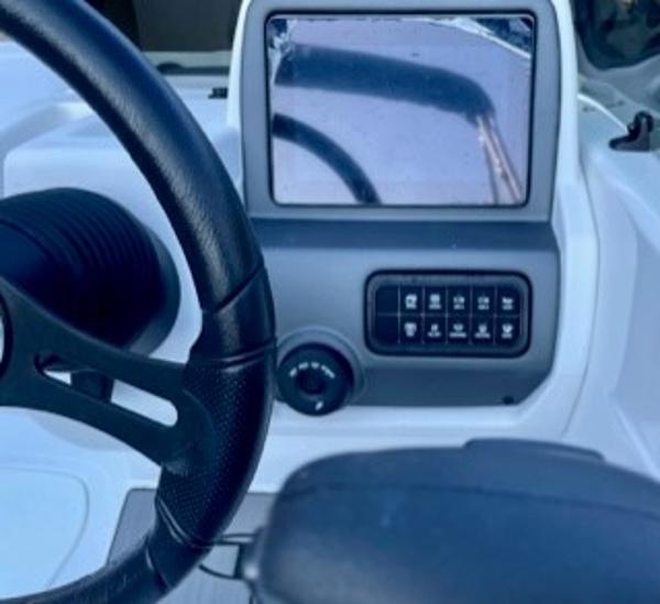 Slide: The Image of 2024 Tahoe T21 boat dashboard with steering wheel and control panel. - 3
