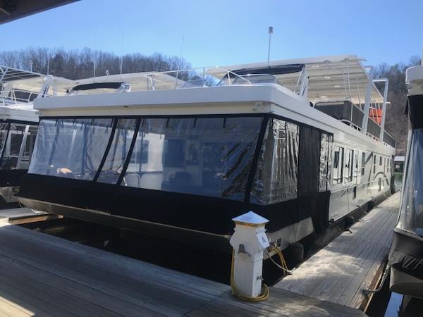 Slide: The Image of 2007 Thoroughbred Houseboat docked at a marina. - 2