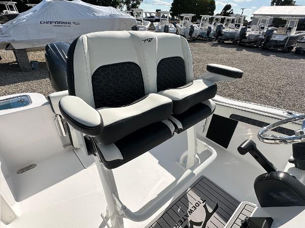 Slide: The Image of 2024 Tidewater 210 CC Adventure boat with dual captain's chairs and steering console. - 38