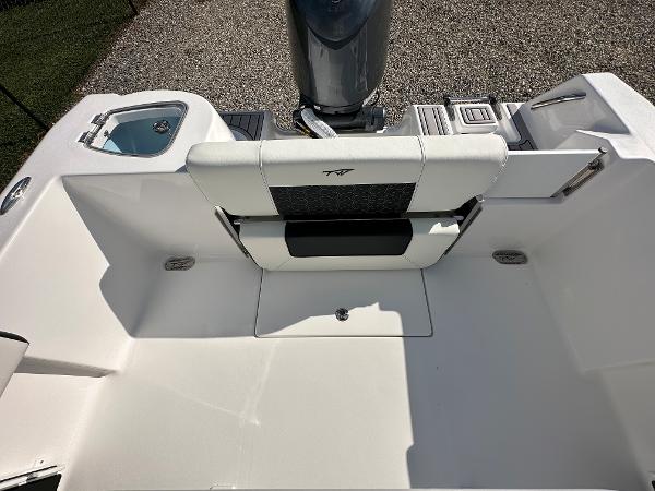 Slide: The Image of 2024 Tidewater 210 CC Adventure boat interior with seating and engine. - 42