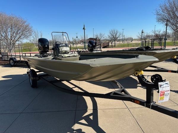 Slide: The Image of 2024 Tracker Grizzly 1754 SC boat on a trailer in a parking lot. - 0