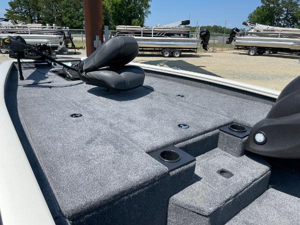 Slide: The Image of 2023 Tracker Pro Team 190 TX fishing boat deck with seating and storage compartments. - 13