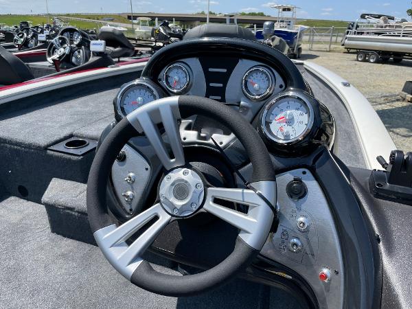 Slide: The Image of 2023 Tracker Pro Team 190 TX boat dashboard with steering wheel and gauges. - 7