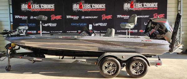 Slide: The Image of 2024 Triton 19 TrX Patriot bass boat on display in showroom. - 1