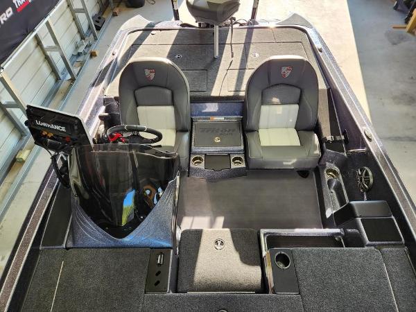 Slide: The Image of 2024 Triton 19 TrX Patriot boat interior with dual seats and control panel. - 10