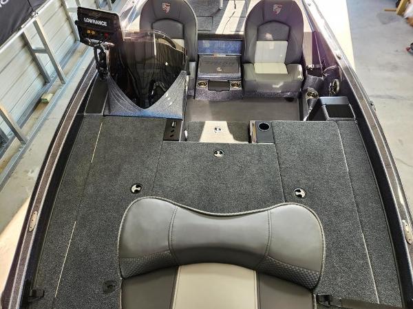 Slide: The Image of 2024 Triton 19 TrX Patriot boat interior with seating and navigation equipment. - 11