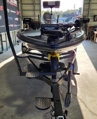 Slide: The Image of 2024 Triton 19 TrX Patriot boat in garage, equipped with Lowrance electronics. - 12