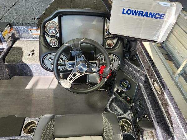 Slide: The Image of 2024 Triton 19 TrX Patriot boat cockpit with Lowrance electronics and modern steering wheel. - 5