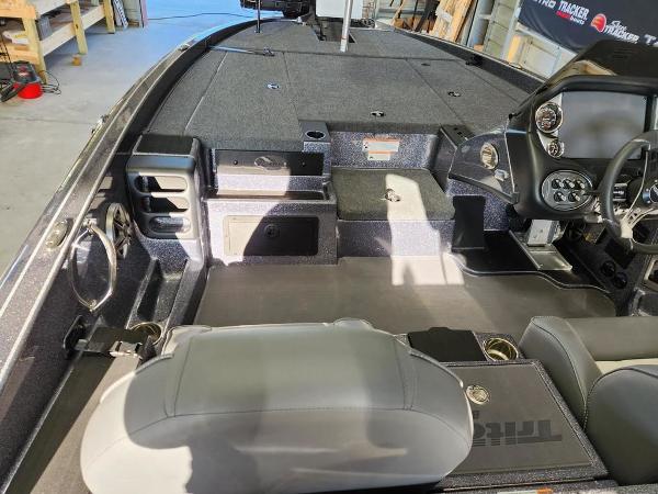 Slide: The Image of 2024 Triton 19 TrX Patriot boat interior with seating and dashboard. - 7