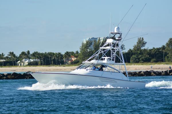 Slide: The Image of 2025 Viking 54 Open yacht cruising near a scenic coastline. - 0