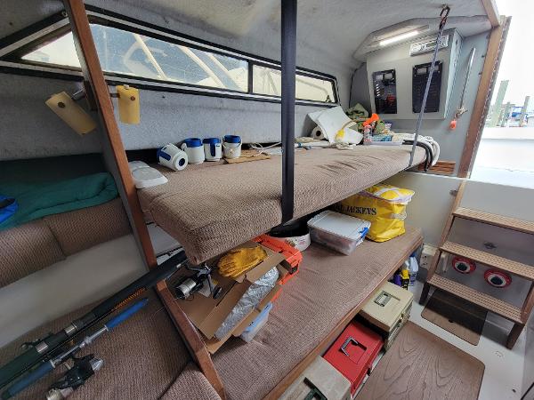 Slide: The Image of Interior of 1986 Wellcraft 2800 Coastal Offshore Fisherman boat with storage and sleeping area. - 6