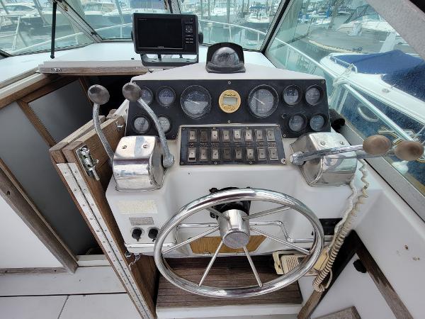 Slide: The Image of 1986 Wellcraft 2800 Coastal Offshore Fisherman boat helm with steering wheel and control panel. - 8